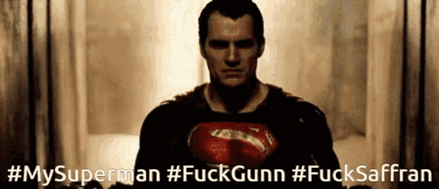 a man in a superman costume with the words #mysuperman #fuckgunn #fucksaffran on the bottom