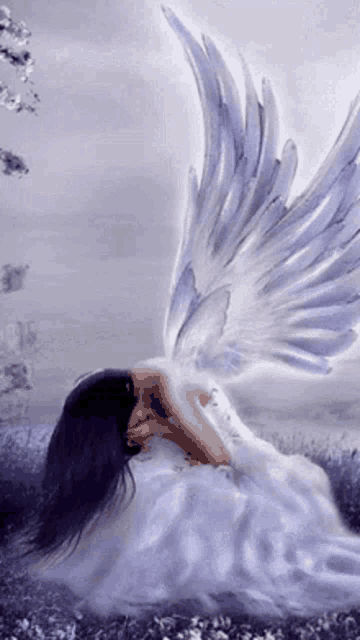 a woman in a white dress with purple wings is laying in a field .