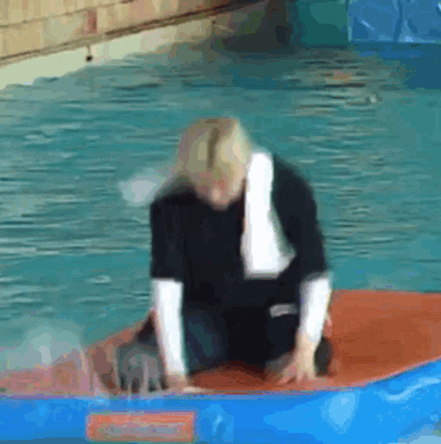 a person is sitting on a raft in a pool