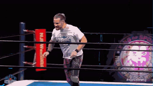 a wrestler in a ring with the hashtag #njpwstrong