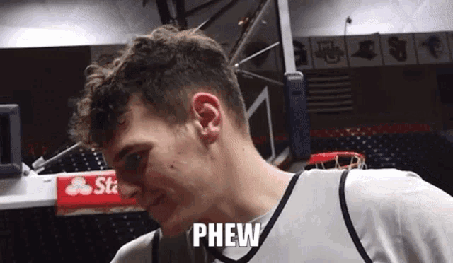 a basketball player with the word phew written on his face