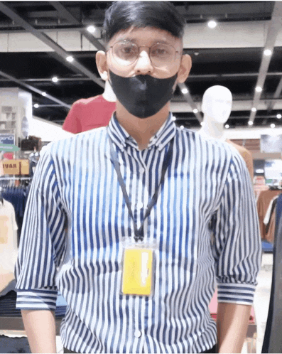 a man wearing a striped shirt and a lanyard with a name tag that says ivan on it