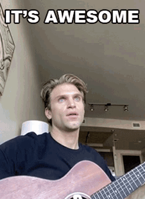 a man playing a guitar with the words " it 's awesome " on the bottom