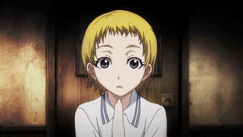 a young girl with blonde hair and blue eyes holds her hand to her mouth