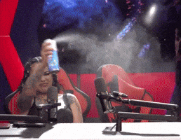 a woman sitting in a red chair spraying something