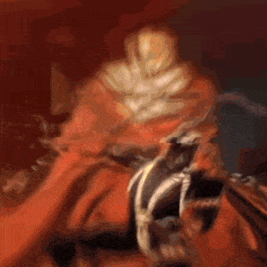 a blurred image of a spawn character with a red cape