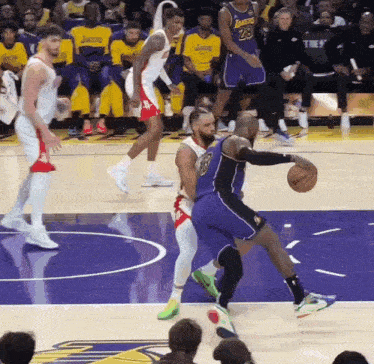 a basketball player with the number 28 on his jersey is dribbling the ball