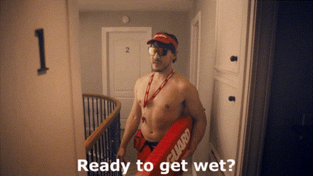 a shirtless man is holding a life preserver and asking if he is ready to get wet .