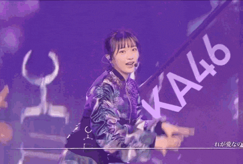 a girl in a purple jacket is standing in front of a sign that says 46 .