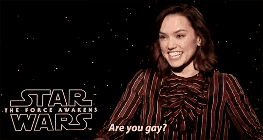a woman is smiling in front of a star wars logo
