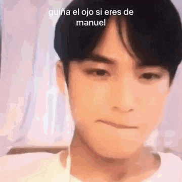 a close up of a person 's face with the words `` guiana el ojo si eres de manuel '' on it .