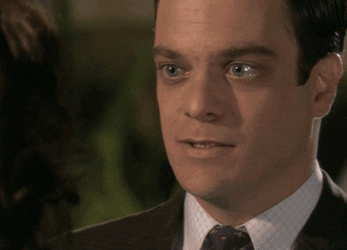 a man in a suit and tie looks at something