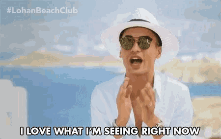 a man wearing a white hat and sunglasses says i love what i 'm seeing right now
