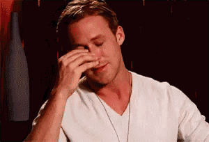 a man in a white shirt is rubbing his nose .