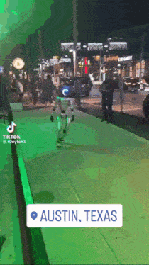 a video of a robot walking down a street in austin texas