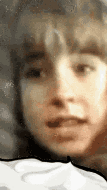 a close up of a person 's face with a white border