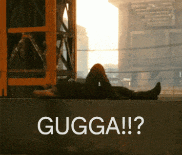 a man is laying on a wall with the words gugga written on it