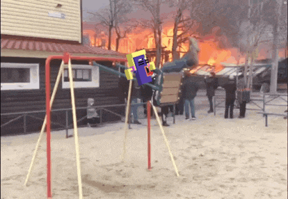 a person is sitting on a swing in front of a burning building
