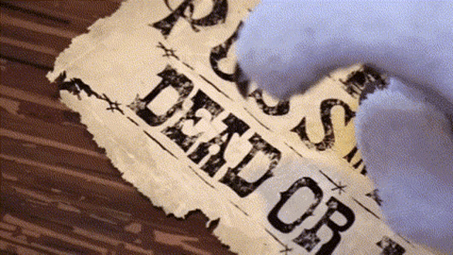 a torn piece of paper with dead or alive written on it