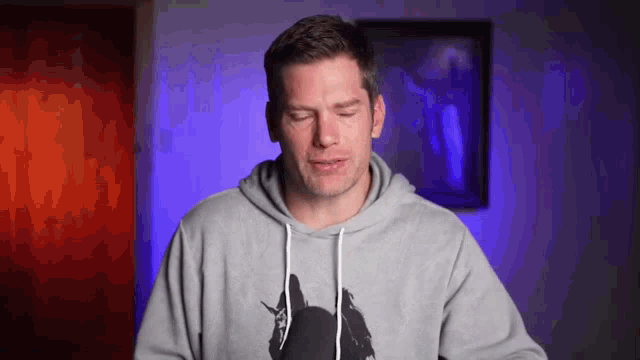 a man wearing a hoodie with a picture of a unicorn on it