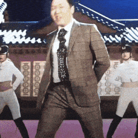 a man in a suit and tie is dancing with two women