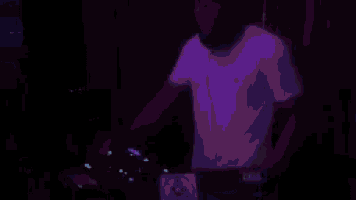a man in a white shirt is playing a dj set