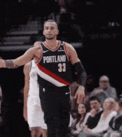 a basketball player wearing a jersey that says portland on it