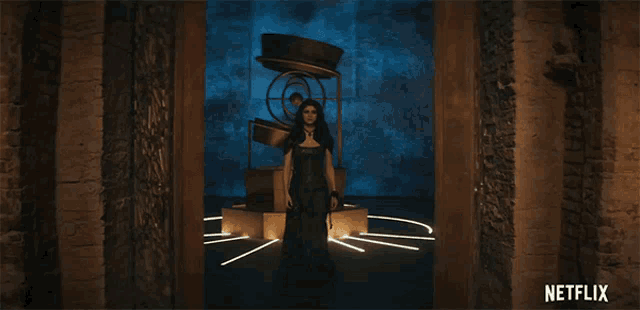 a woman in a black dress stands in a dark room with a netflix logo in the corner