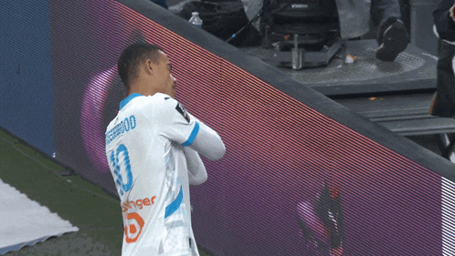 a soccer player wearing a white jersey with the number 80 on the back
