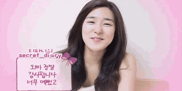 a woman is smiling in front of a pink sign that reads secret_diary