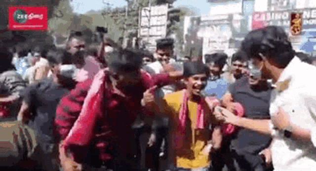 a crowd of people are dancing in front of a casino .