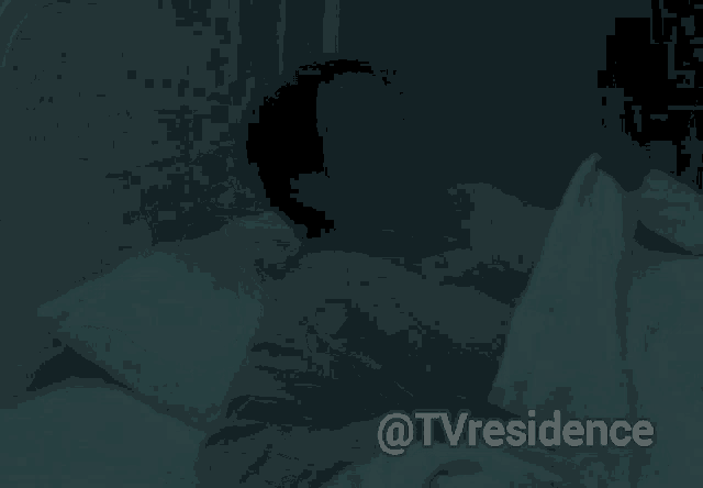 a woman laying in a bed with the words @tvresidence below her