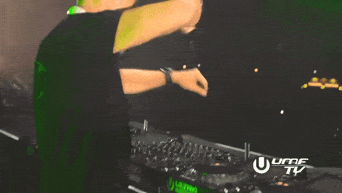 a man is dancing in front of a uhf tv sign