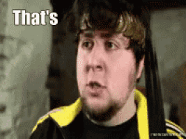 a man with a beard is wearing a black shirt and a yellow jacket and says that 's