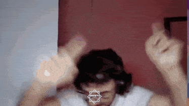 a man wearing headphones is giving the middle finger in a video