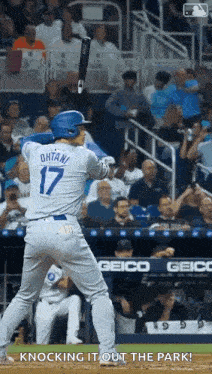 a baseball player with the number 17 on his jersey is getting ready to bat