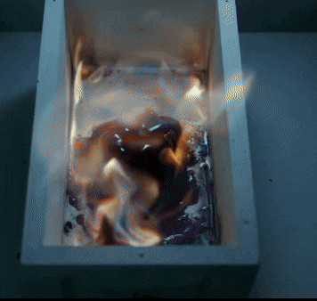 a white box with flames coming out of it is on a table