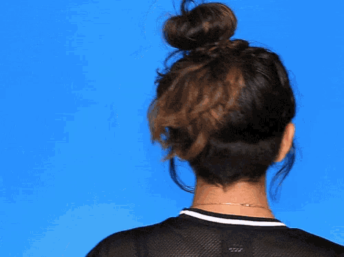 the back of a woman 's head with a bun