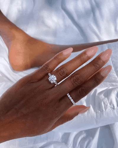 a close up of a woman 's hand with a ring on it