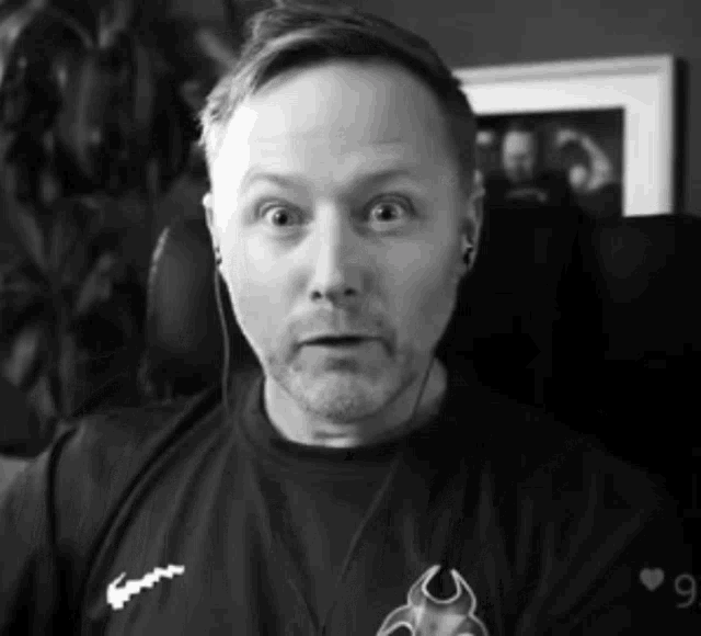 a black and white photo of a man wearing headphones and a shirt that has the number 9 on it
