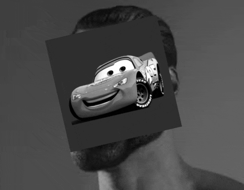 a man 's face is covered by a picture of lightning mcqueen from cars