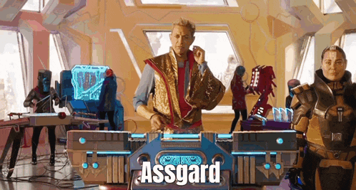 a man playing a dj set with the word assgard on the front