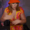 a woman wearing a hat and a colorful dress is dancing .
