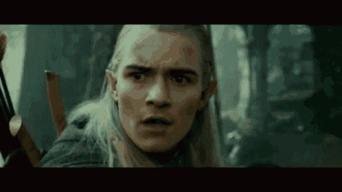 a close up of a man 's face with a bow and arrow .