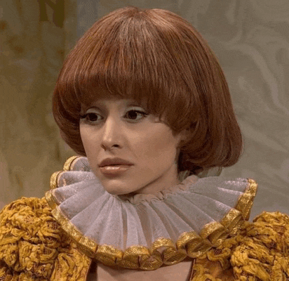 a woman with red hair is wearing a gold and white collar