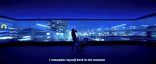 a person is standing in front of a large screen with the words i remember myself back in the moment