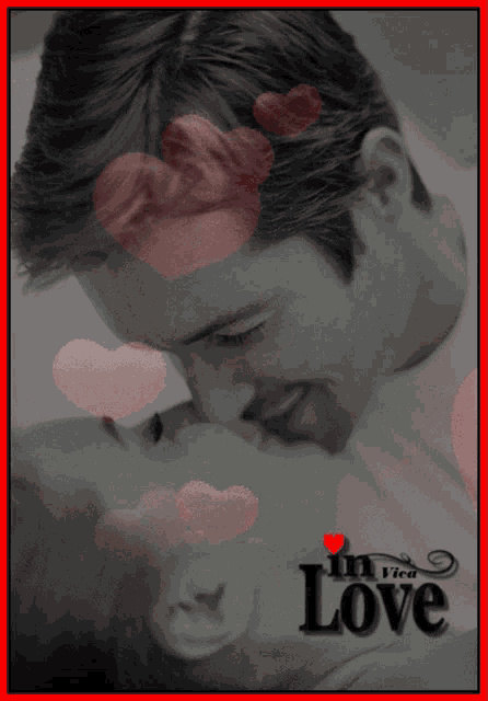 a black and white photo of a man kissing a woman with the word love in the bottom right