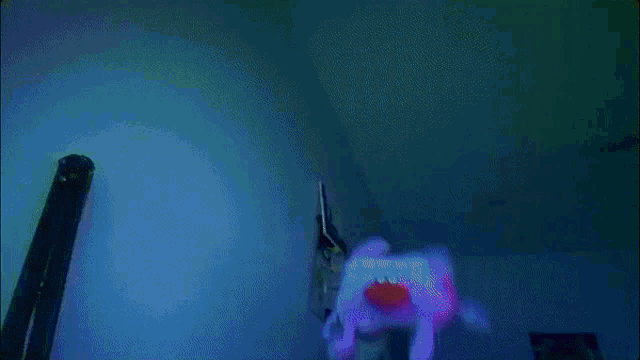 a stuffed animal with a red nose is hanging from the ceiling