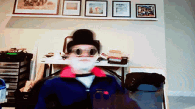 a person wearing a top hat and goggles looks at the camera
