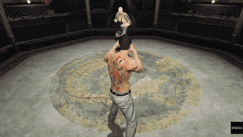 a man with a tattoo on his back is fighting another man